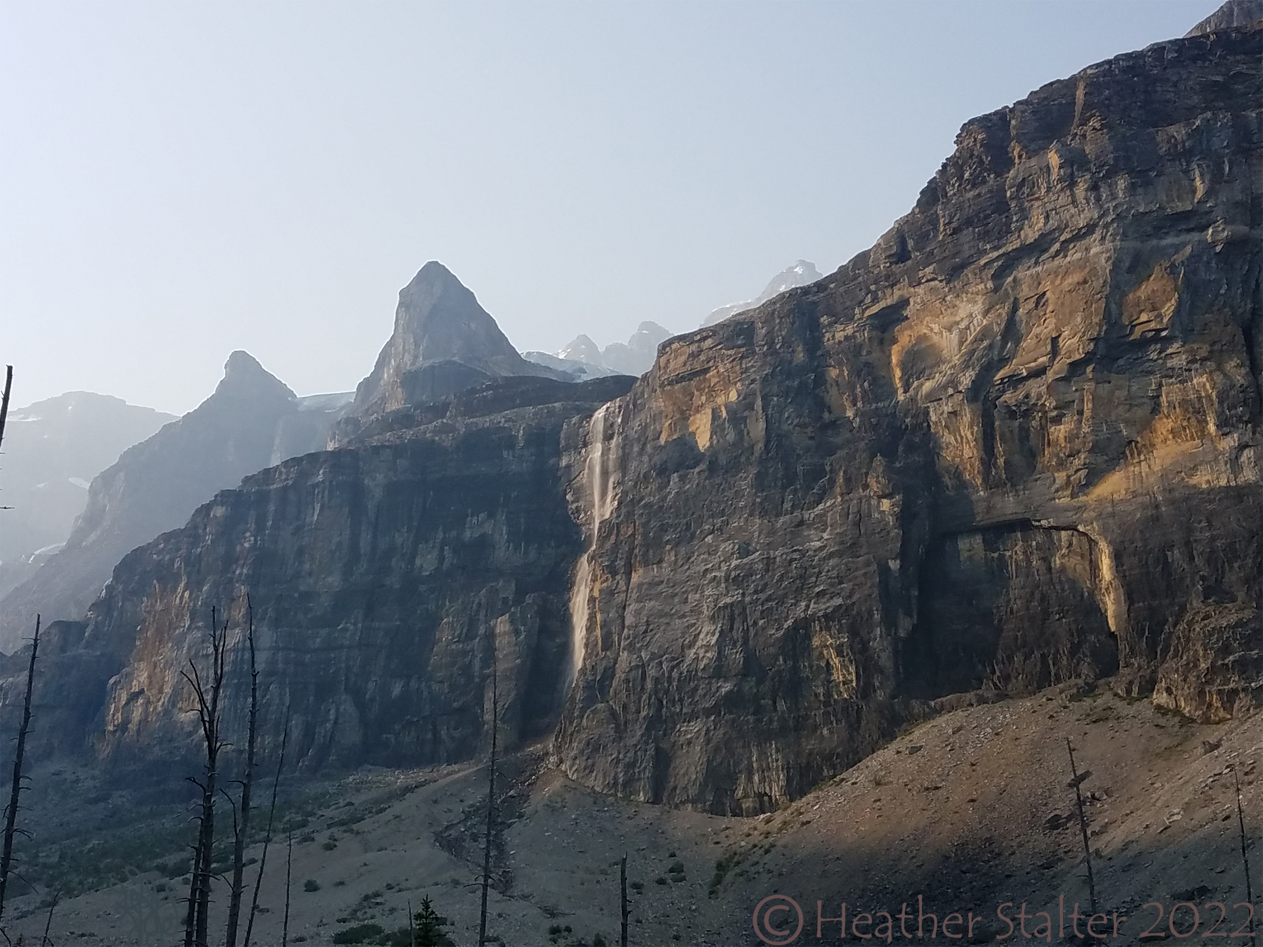rocky mountains with a slender waterfall
